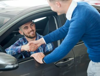 car-seller-customer-handshake-car-dealership_7502-4099